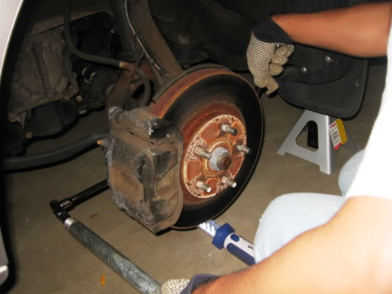 Remove the brake caliper and rotor