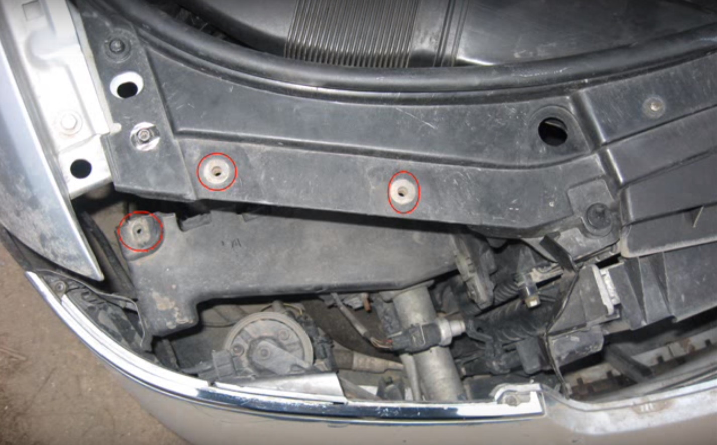 Remove the three bolts from the passenger side headlight.