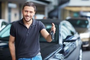 man showing off car purchase