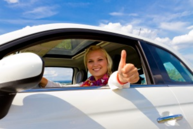 Driver giving thumbs up out car window