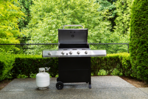 a grill and propane tank on a patio