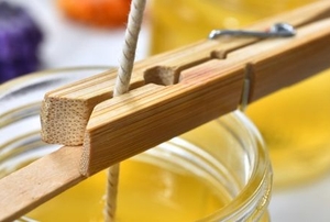 clothes pin holding a wick during the candle-making process