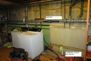 A laundry room in need of a new sink and drain.