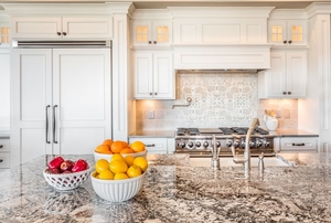 An integrated, or hidden, fridge inside of a new kitchen.