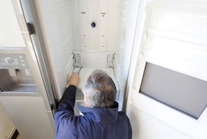 Man repairing refrigerator