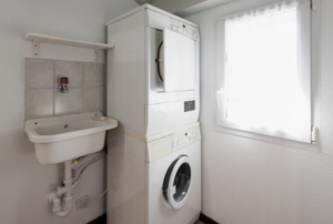 stackable washer and dryer unit in a bathroom