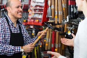 salesman showing a hammer to a customer