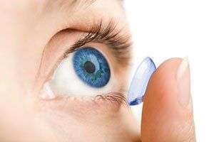Image of a person putting in contacts.