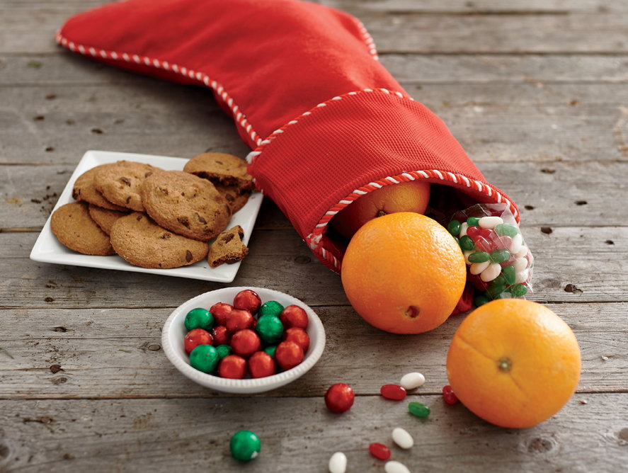 Christmas stocking with gifts oranges and cookies