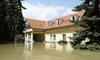 house with flooding waters surrounding it