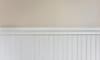 White wainscoting against a beige wall.