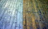 Two different colors of floorboards making up the same floor.