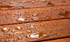 water droplets beading up on a deck