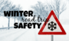 A snowy road with the words "winter road trip safety."