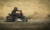 a person in all black on a motorcycle