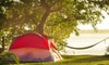 Tent with hammock and sun in the background