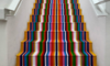 A multi-colored striped set of stairs. 