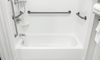 white fiberglass tub and shower with safety handles