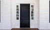 a black door surrounded by windows
