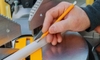 hand measuring an angle with a saw