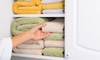A linen closet with folded towels.
