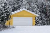yellow garage in snowy woods