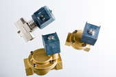 Three isolated solenoid valves against a gray background.