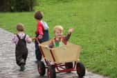 children playing with wooden wagon