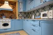 blue retro fridge in modern kitchen with houseplant