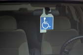 handicapped sign hanging inside a car