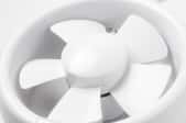 A small, white, plastic exhaust fan.
