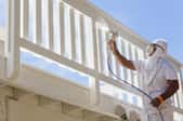 Person painting a balcony railing