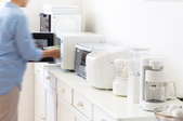 man with kitchen appliances on counter
