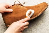 hand cleaning suede shoe with brush