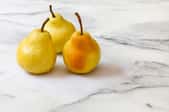 Marble counter with three pears on it