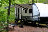 camper trailer parked in the woods