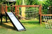 home playground with slide, bridge, and rope ladder