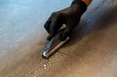 gloved hand using grouting tool