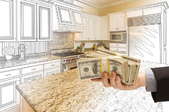 Wad of cash in front of a kitchen remodel design