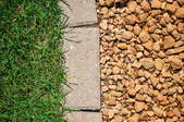gravel and grass separated by paving stones