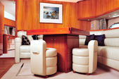inside of a boat with white furniture and wood accents