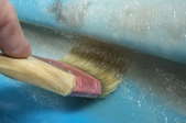 a paint brush on a blue surface