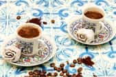 Cups and saucers on a tiled surface