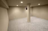 a basement room with carpet
