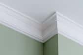 White crown molding on a green painted wall