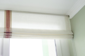 white Roman blinds on a window