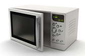 A white microwave, ready for use.