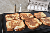 french toast cooking on a griddle