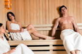 Three people in a sauna.