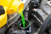 coolant being poured into a car